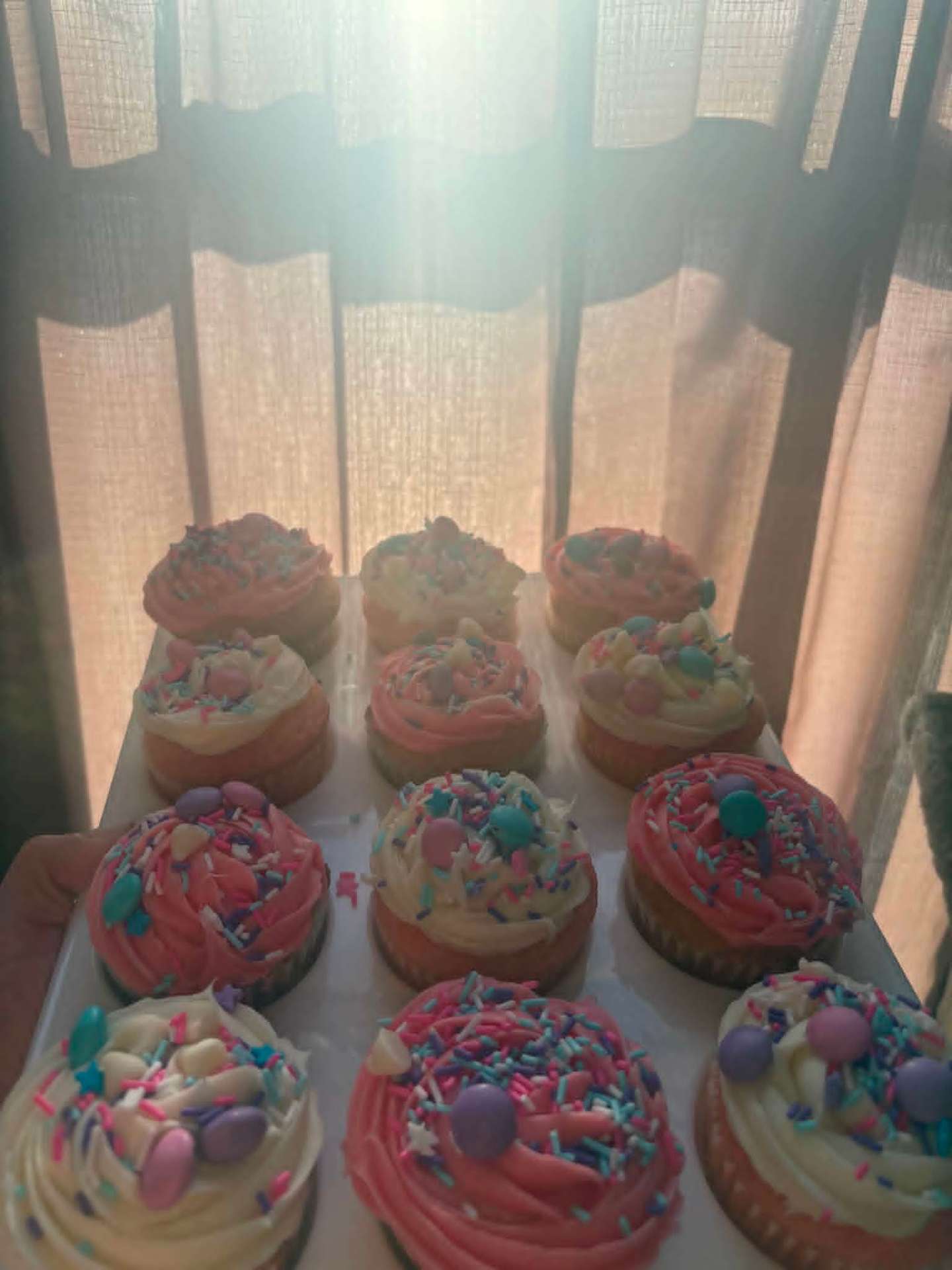 Pink and vanilla cupcakes with pastel sprinkles